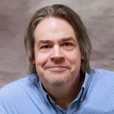 Headshot of white male in blue shirt