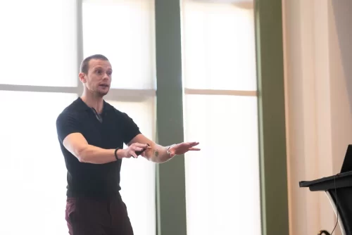 Russell-on-stage-using-his-hands-while-talking