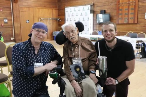 Russell-sitting-with-three-people-smiling