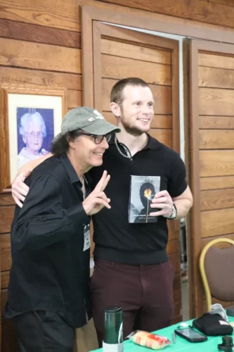 Russell-standing-with-a-person-holding-his-book